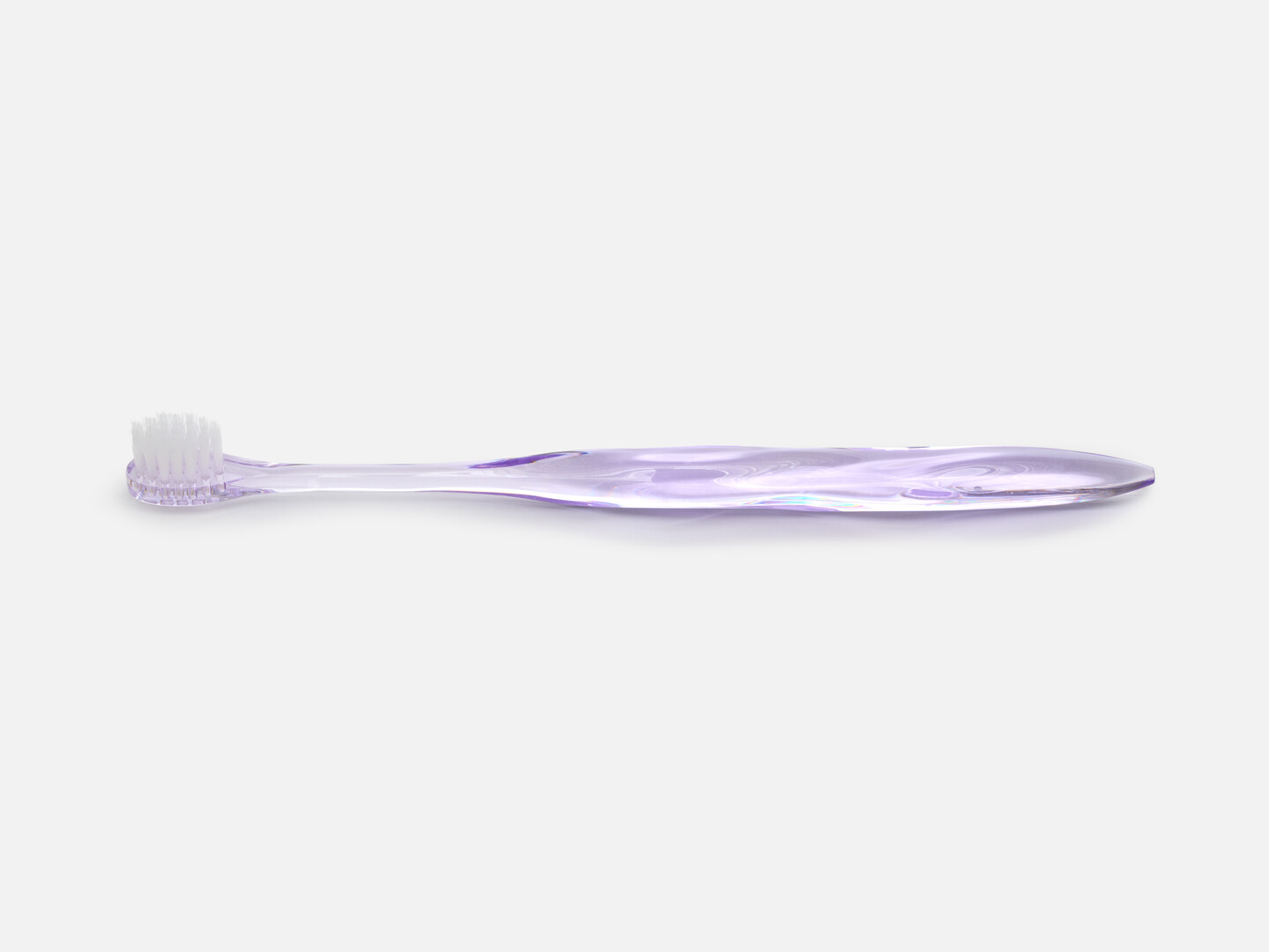 Misoka toothbrush in purple, a transparent toothbrush shaped in a organic form from Japan House London.