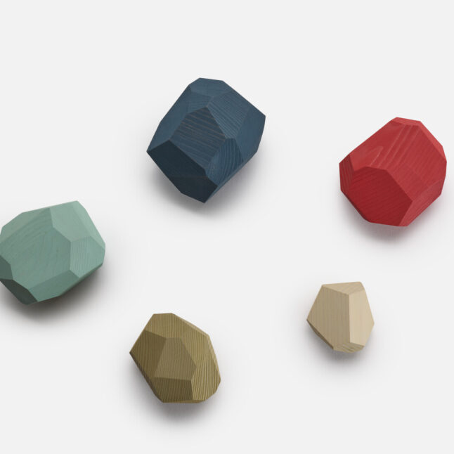 Five muted multi coloured wooden toy blocks