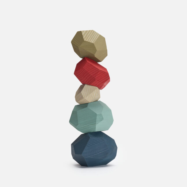 A stock of muted multi coloured wooden toy blocks