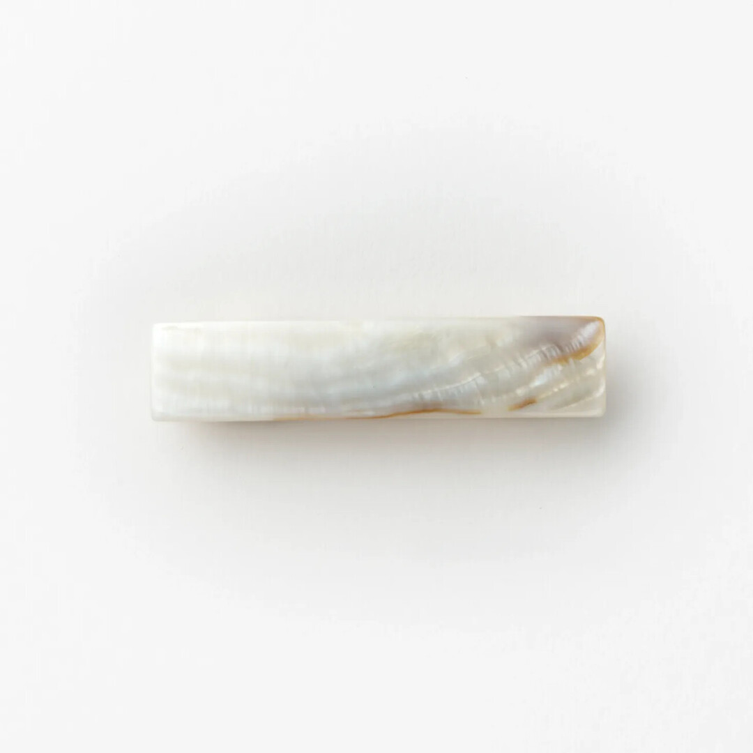 A small rectangular mother of pearl hair barrette by Jinbo Pearls from Japan House London.