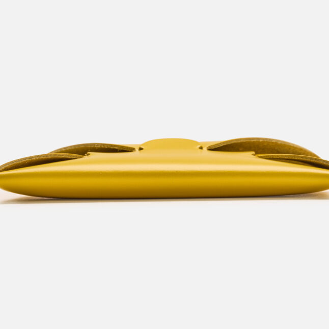 A side profile of seamless leather card holder in yellow from Japan House London
