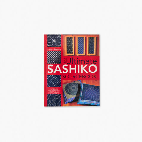 Book cover showing embroidered pillows and patterns made with white threads on indigo blue base using sashiko stitching technique.