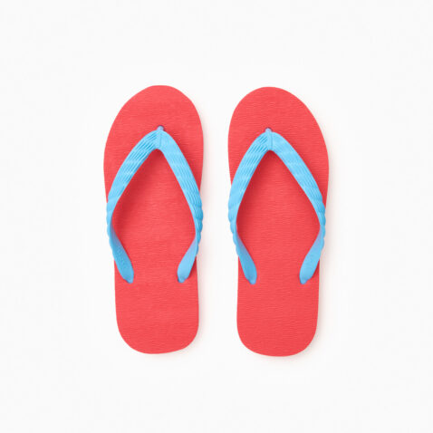 Top view of a pair of red rubber flip-flops with light blue straps.