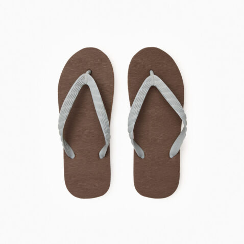 Top view of a pair of brown rubber flip-flops with grey straps.