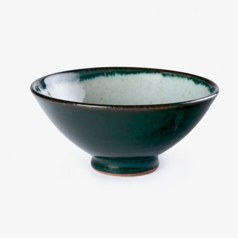 A dark green Japanese porcelain rice bowl sitting on a white background.
