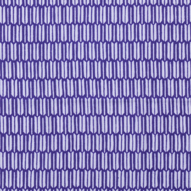 Close up of cotton fabric dyed with a pattern of feathers in white and purple