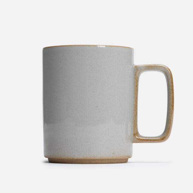 A large mug with a pale grey glossy glaze seen directly from the side