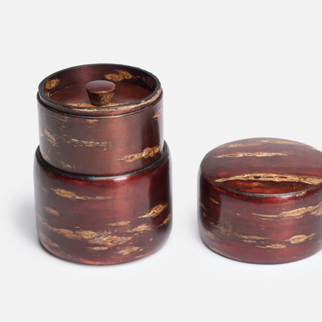 A sakura bark tea caddy with the first lid placed next to it