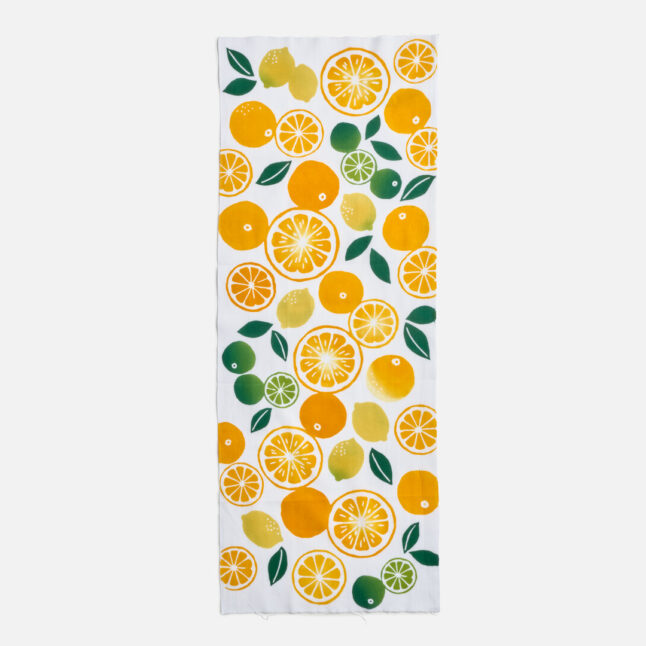 Cotton cloth illustrated with pattern of citrus fruit in orange, yellow and green