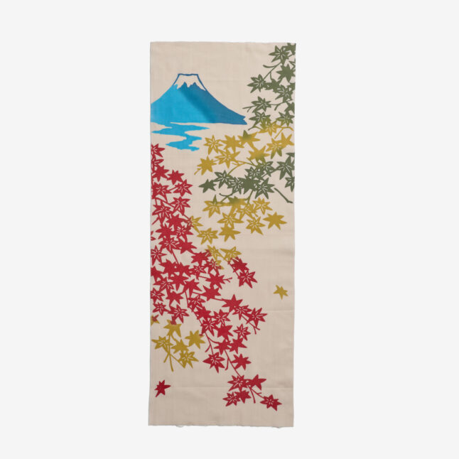 A cotton hand towel dyed with the illustration of light blue Mount Fuji and autumnal leaves in red, yellow and green