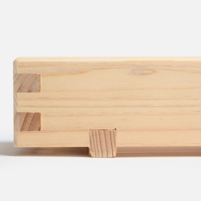 A wooden hinoki soap dish with a foot