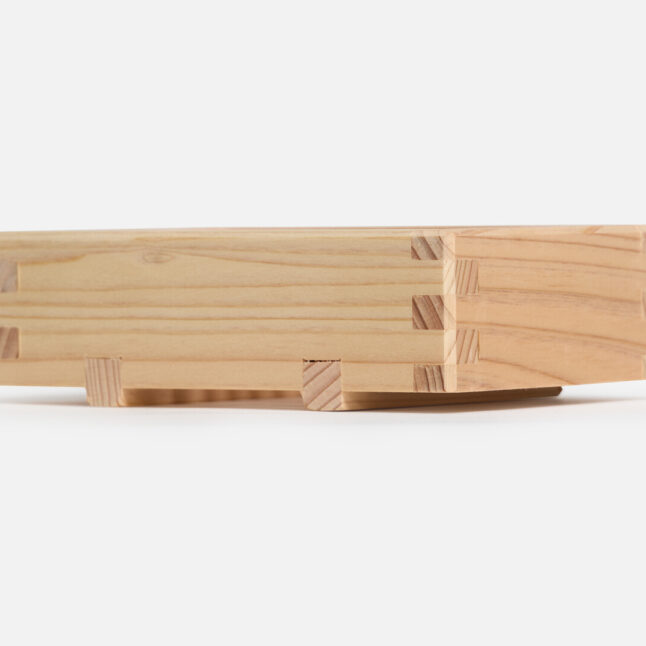 A wooden hinoki soap dish with feet