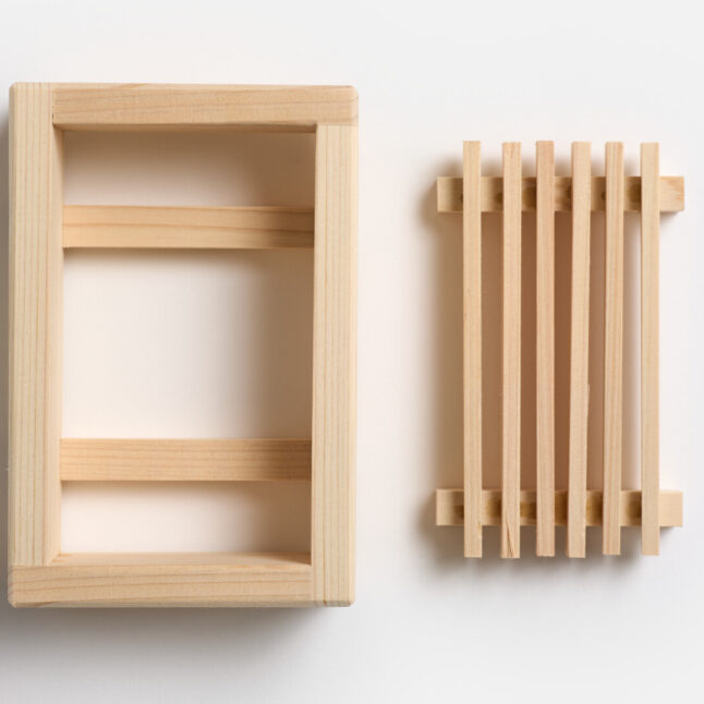 A wooden hinoki soap dish with a removable base