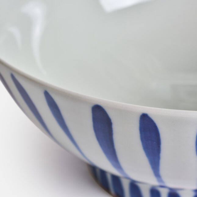 A large white bowl with blue stripes from Japan House London