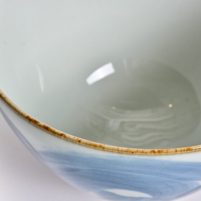 A white ceramic rice bowl with a karakusa pattern from Japan House London