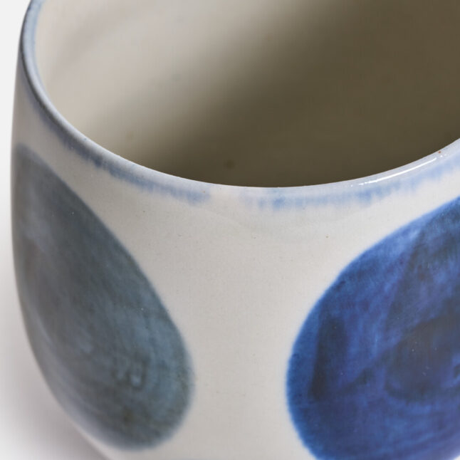 A rounded ceramic cup with a blue round pattern from Japan House London
