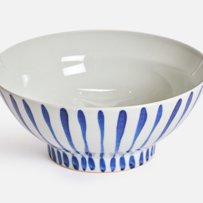 A large white bowl with blue stripes from Japan House London
