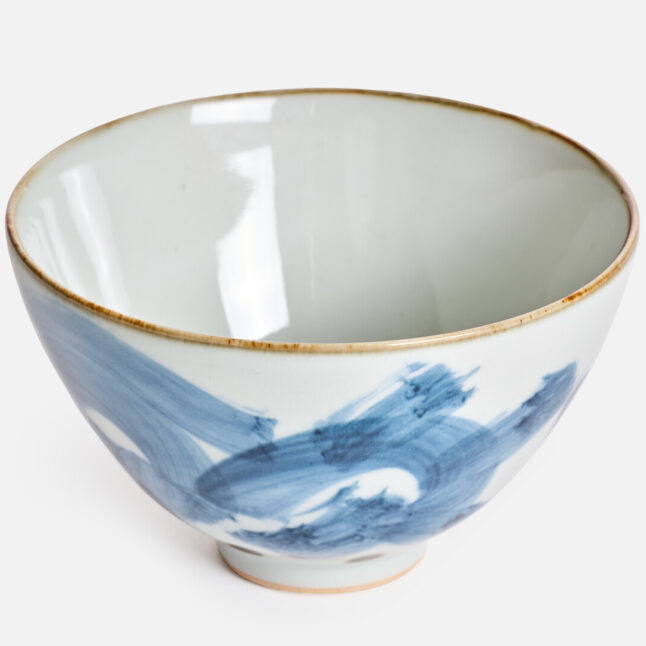 A white ceramic rice bowl with a karakusa pattern from Japan House London