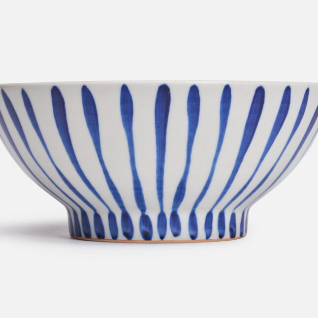 A large white bowl with blue stripes from Japan House London