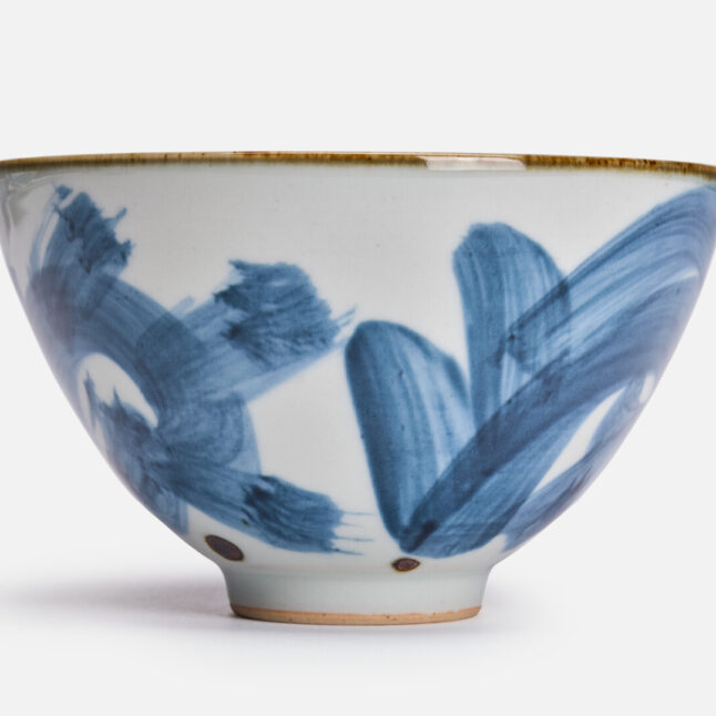 A white ceramic rice bowl with a karakusa pattern from Japan House London