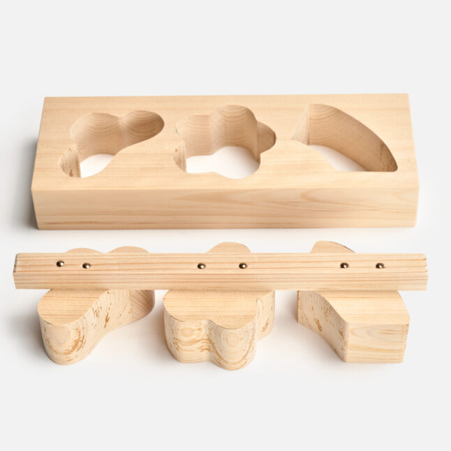 Two piece wooden food mould in three auspicious shapes laid out