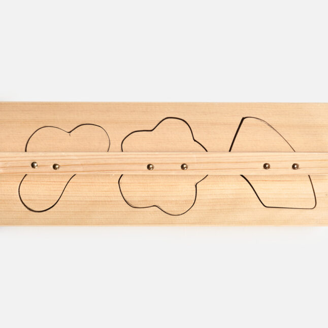 Two piece wooden food mould in three auspicious shapes placed into each other