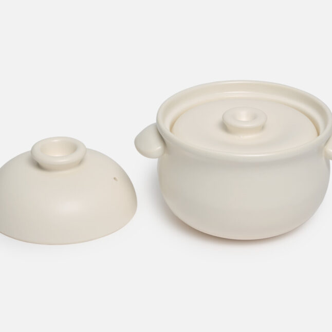 Large white Taiseigama rice pot with outer lid off and the inner lid on from Japan House London