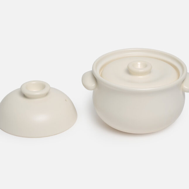 Small white Taiseigama rice pot with outer lid off and the inner lid on from Japan House London