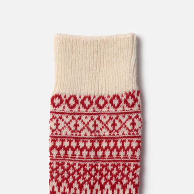 Close up detail of pattern of white and red wool jacquard socks from Japan House London