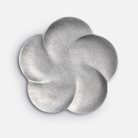 Silver colour tin plate in the shape of the plum flower motif from Japan House London.