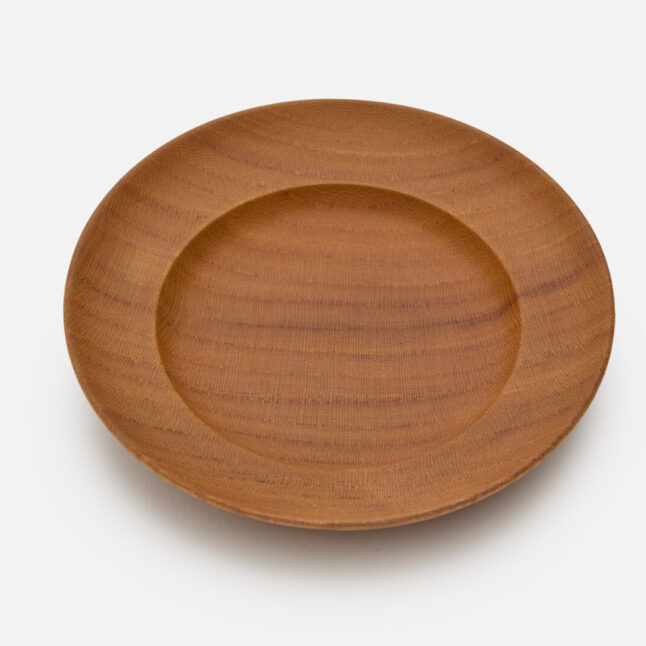 A wooden lacquered plate from Japan House London.
