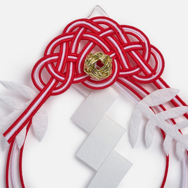 Red and white mizuhiki ornament from Japan House London.
