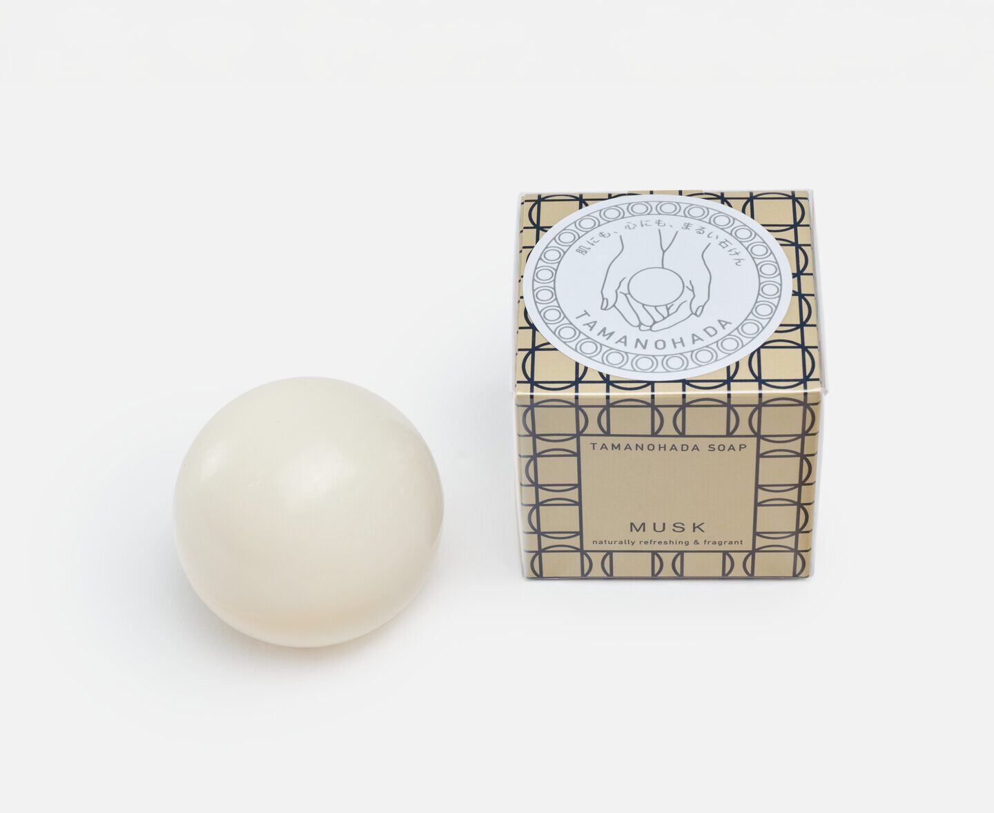 A soap in the shape of a spherical ball and a square box of gold package