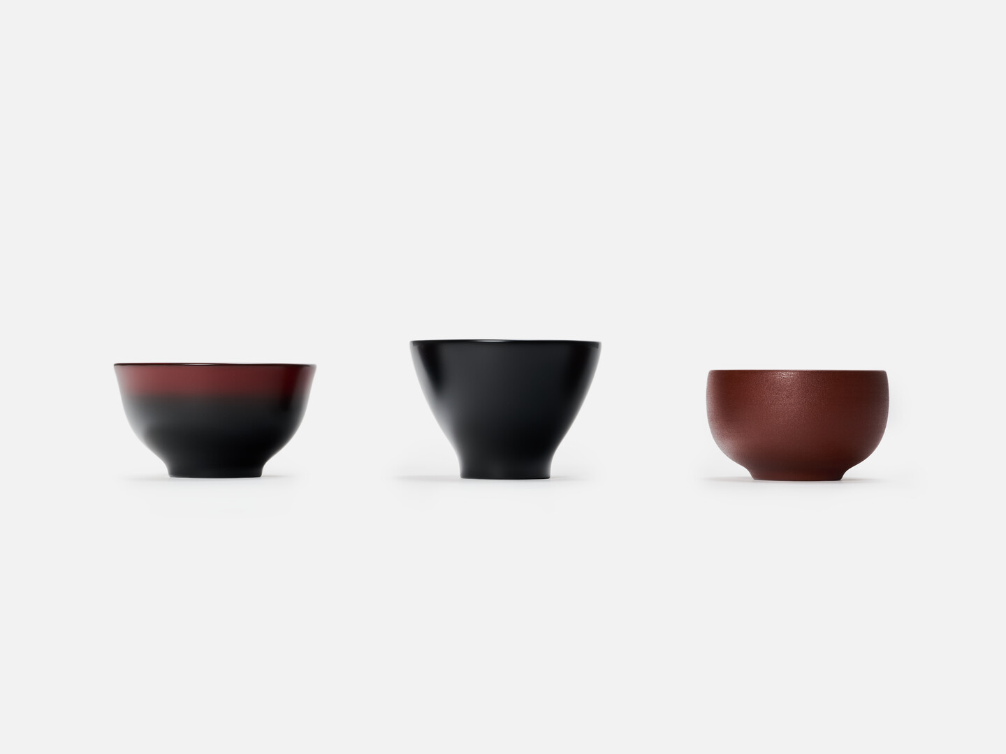 Three lacquered bowls in red, black and gradation going from red to black