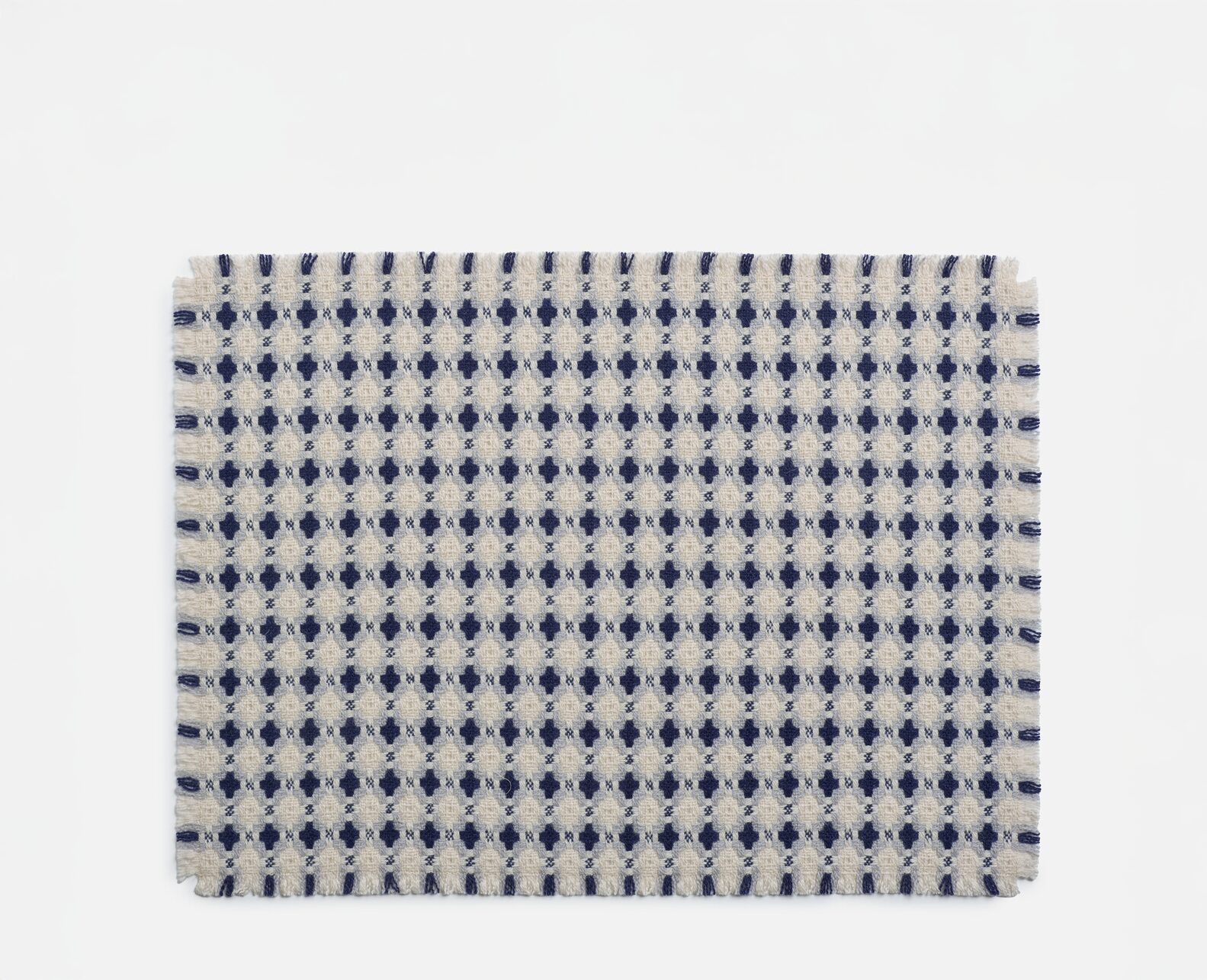 A tablemat with a navy and white chequered pattern