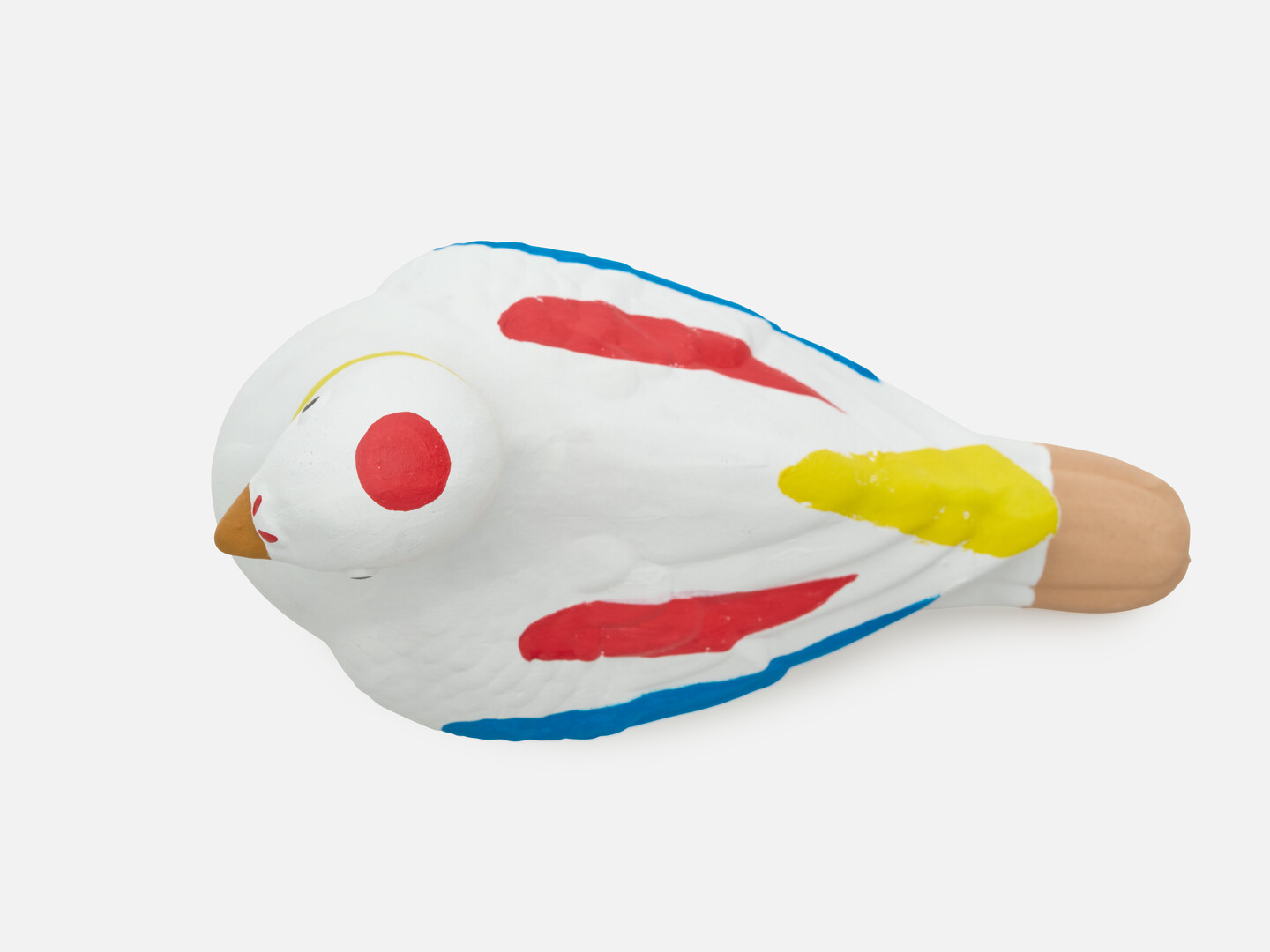A dove figurine with red, yellow and blue markings.