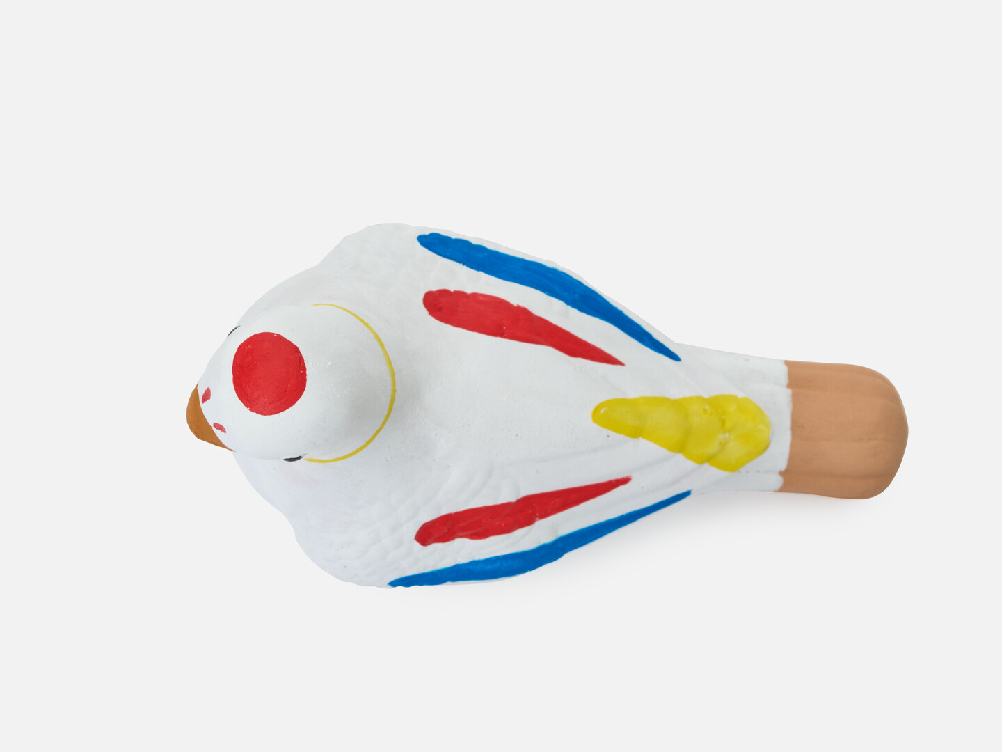 A dove figurine with red, yellow and blue markings.
