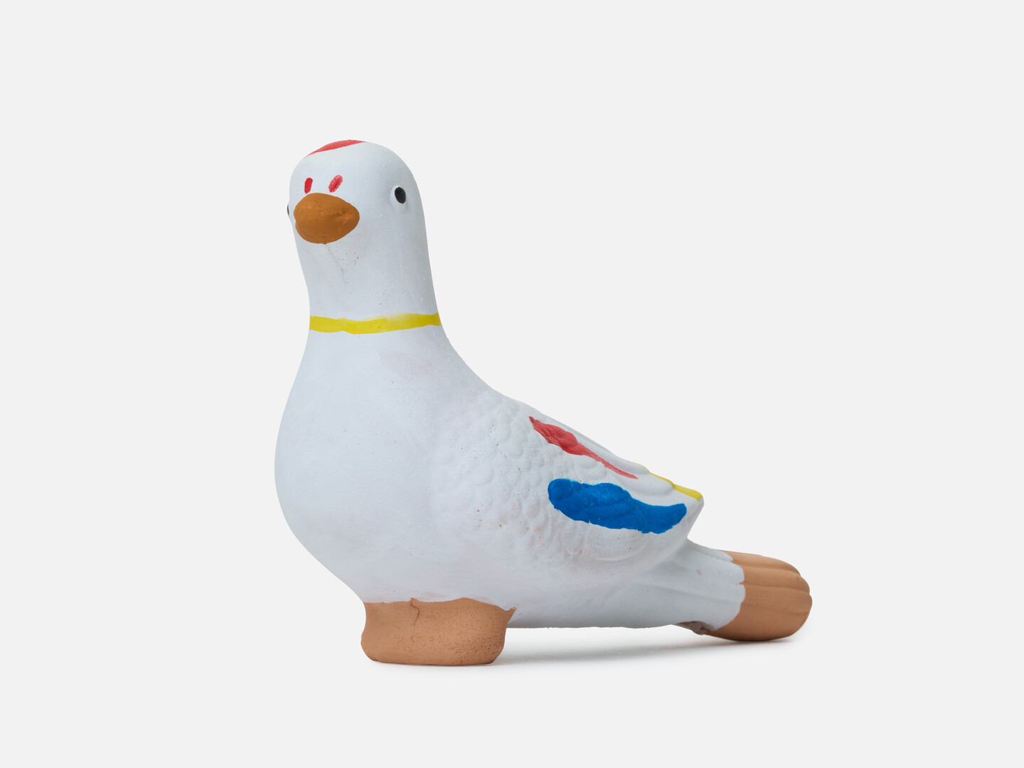 A dove figurine with red, yellow and blue markings.