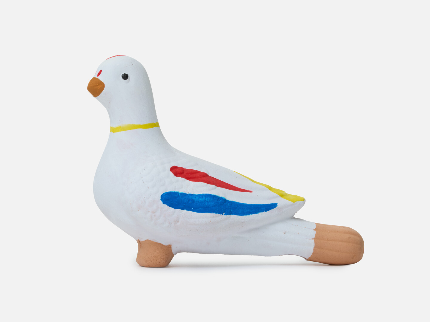 A dove figurine with red, yellow and blue markings.
