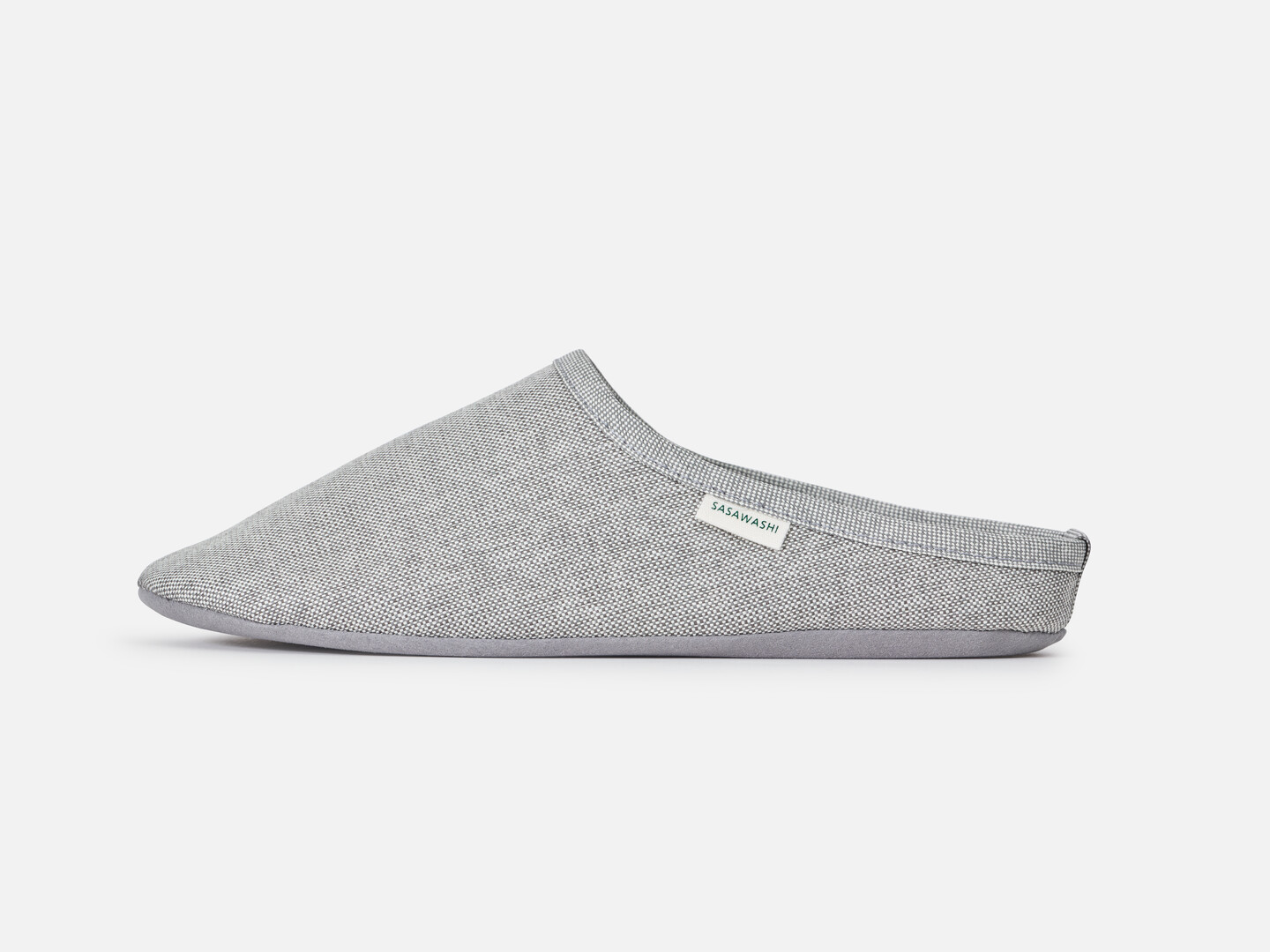 A grey sasawashi slipper from the side with a white label on the side with the words SASAWASHI