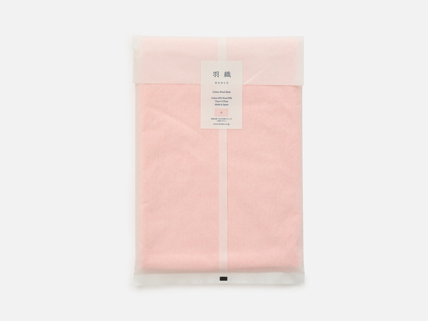 Pink scarf packaged in a white translucent paper
