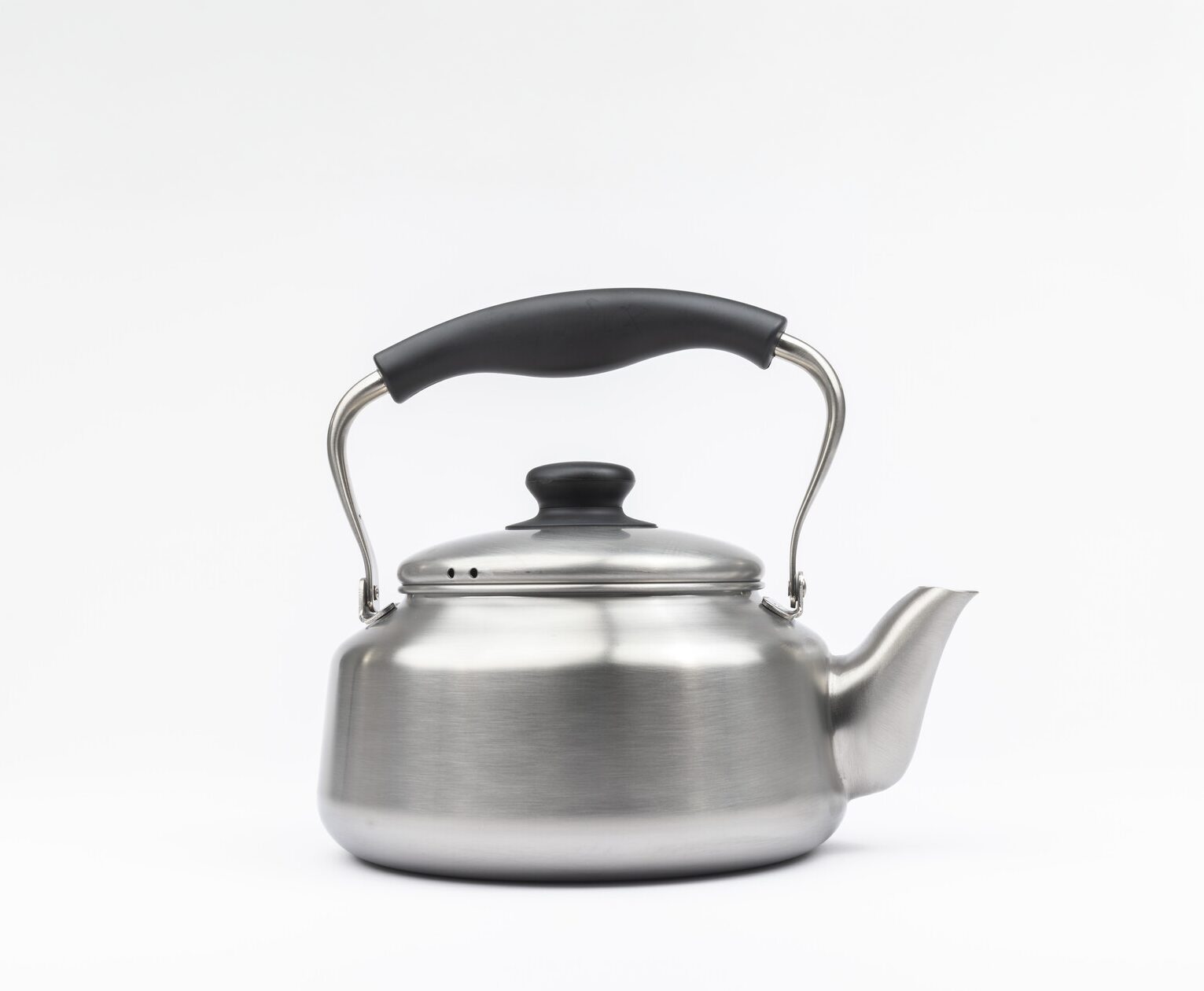 A metal kettle with a black handle and lid handle