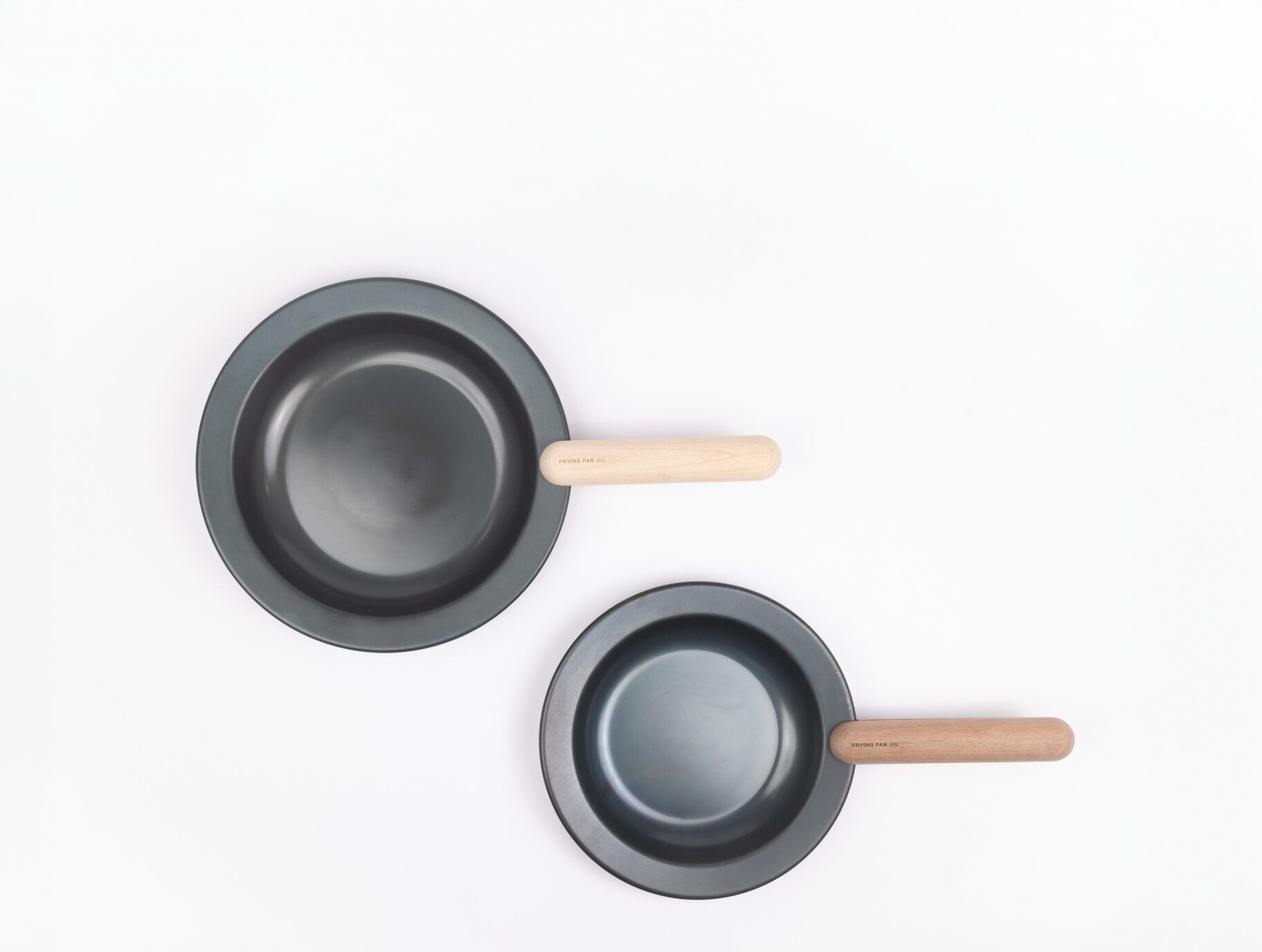 Two frying pans with wooden handles