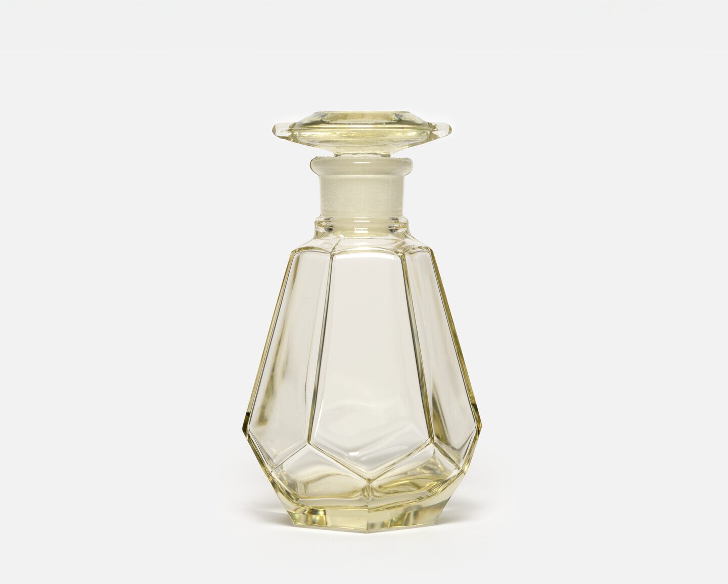 A hexagonal glass soy sauce dispenser