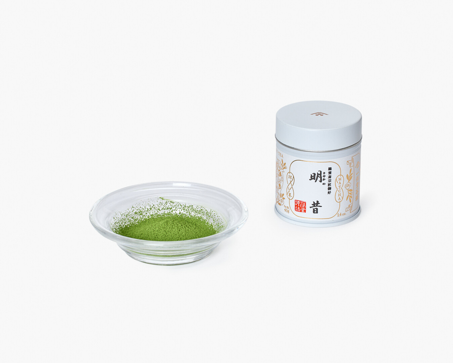 A pot of matcha with a small glass plate with matcha