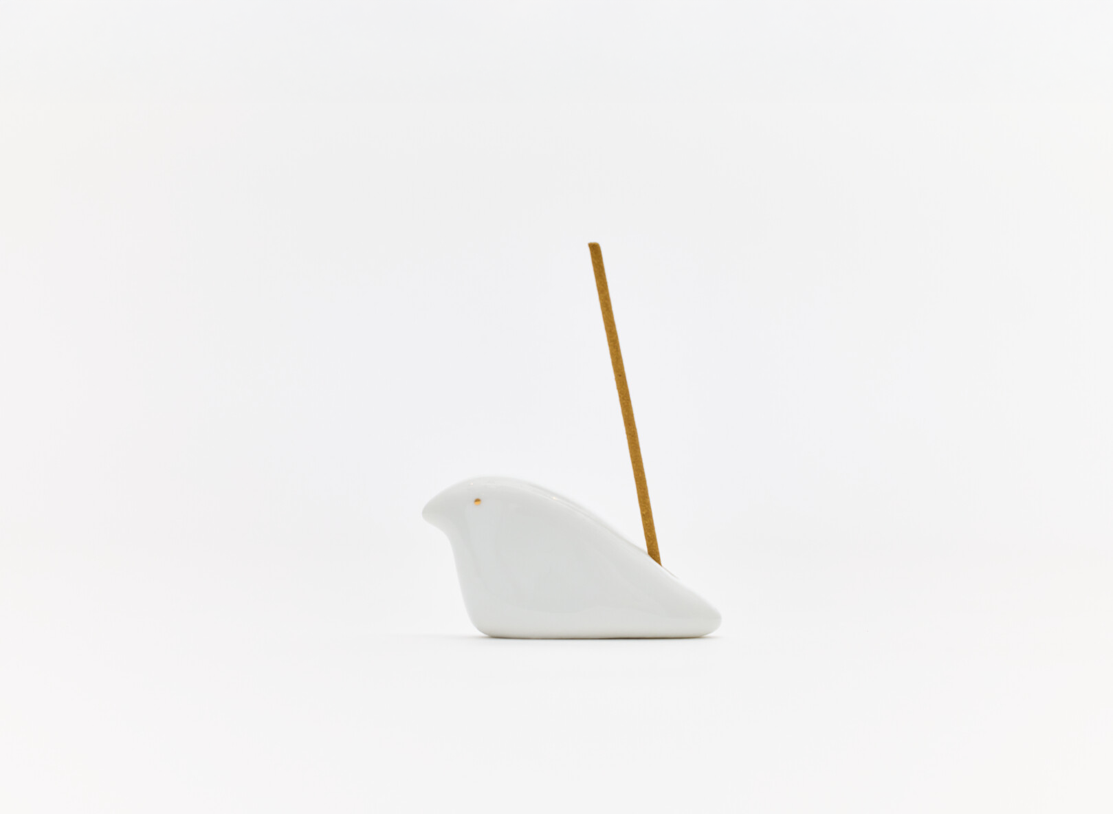 A ceramic dove incense stick holder