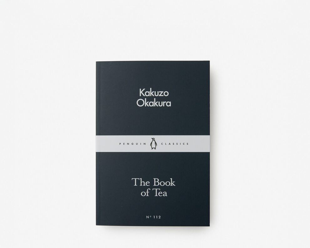 A black book with the words Kakuzo Okakura and the book of tea