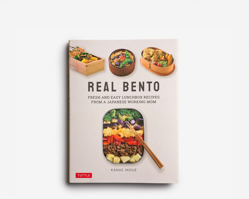 A book with three small pictures of bento boxes and one large one in the middle with the words Real Bento Fresh and Easy Lunchbox recipes from a Japanese working mom Kanae Inoue Tuttle
