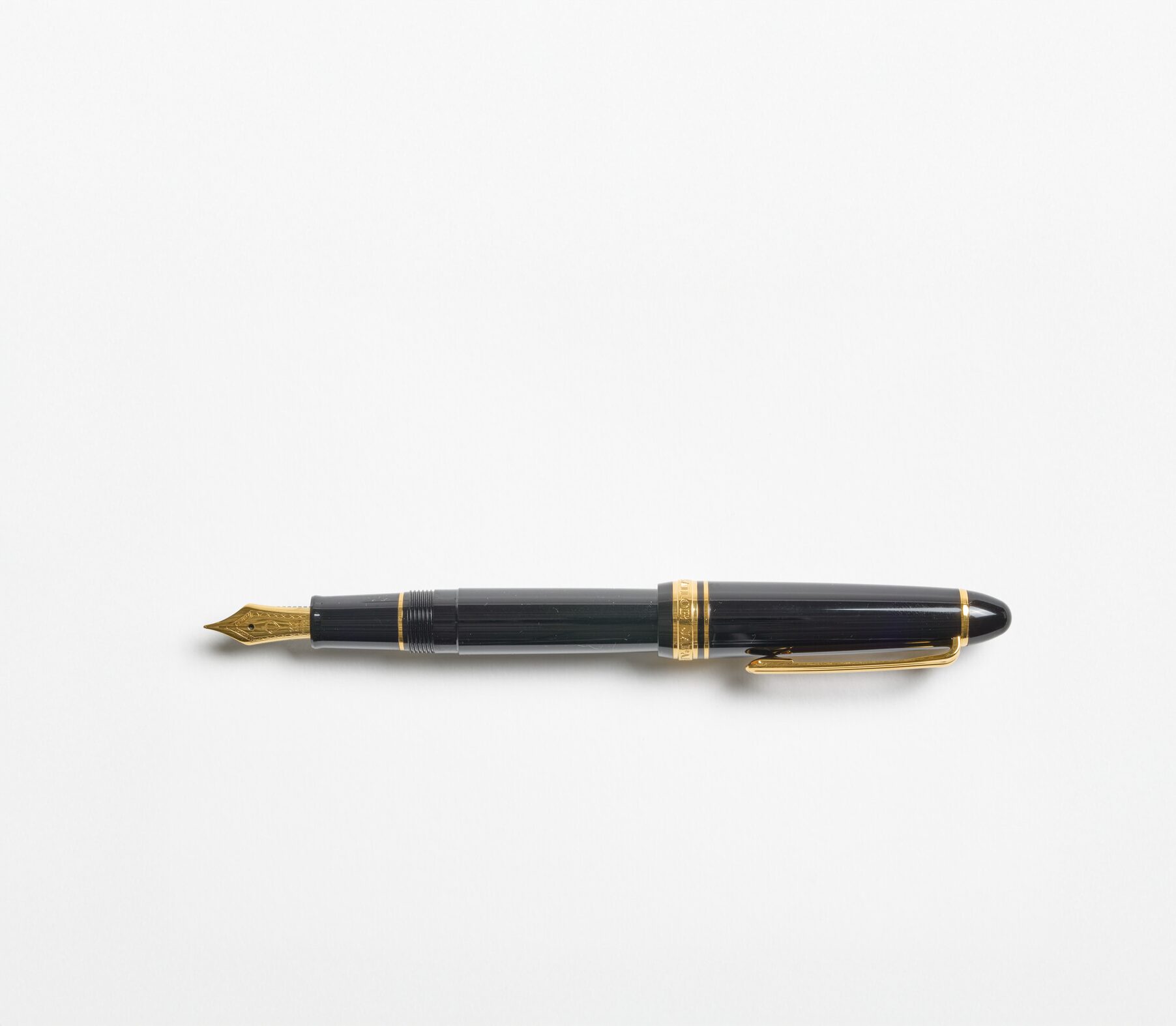 A black fountain pen with a gold nib and details