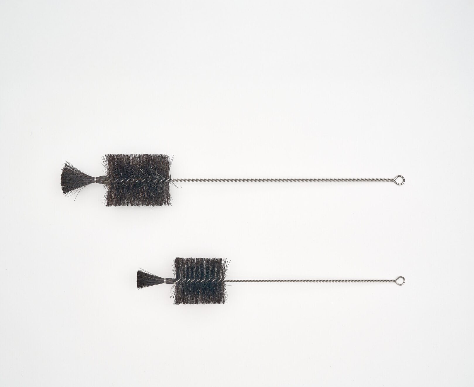 Two brushes with metal handles